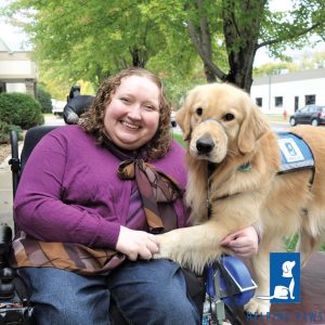 Woman in a wheelchair and a service dog.